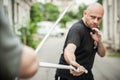 Eskrima and kapap instructor demonstrates machete weapon fighting technique Royalty Free Stock Photo