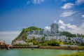 Esmeraldas, Ecuador - March 16, 2016: Beautiful rocky beach with a buildings structure of hotels behind in a beautiful