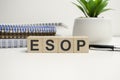 esop sign on the wooden cubes and notepads. Business concept