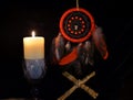 Esoteric and occult still life with vintage magic dreamcatcher and burning candle on witch table altar for mystic rituals and