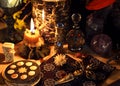 Esoteric and occult still life with vintage magic objects, tarot cards and burning candle on witch table altar for mystic rituals Royalty Free Stock Photo
