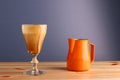 Espesso with ice cream affogato coffee with pitcher on wooden table and grey background. Coffee cold drink with vanilla ice cream