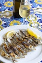 Espeto, Malaga style fish on stick barbecue prepared on olive tree firewoods served with dry fino sherry wine