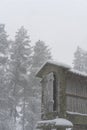 Espigueiro traditional structure for corn storage on a snow white winter landscape with snow falling in the north of Portugal Royalty Free Stock Photo