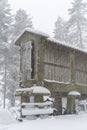 Espigueiro traditional structure for corn storage on a snow white winter landscape with snow falling in the north of Portugal Royalty Free Stock Photo