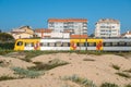 Comboios de Portugal, Portuguese train, passing alongside dunes near Espinho, Portugal Royalty Free Stock Photo