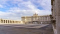 Esplanade and large courtyard of the royal palace of Madrid at sunrise on a day with blue sky and clouds
