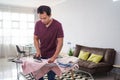 esponsible husband busy with house work, irones his shirt in morning