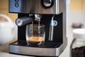 Espresso brewing from a coffee maker in a glass