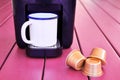 Espresso cappuccino machine, capsules and a vintage mug on a pink wooden table Royalty Free Stock Photo
