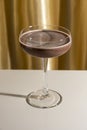 Espresso or chocolate martini cocktail on golden background Royalty Free Stock Photo