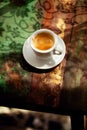 Espresso coffee cup on rustic table with sun Royalty Free Stock Photo