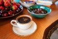 coffee cup with various desserts and fruits