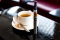 Espresso coffee with an e-cigarette in a pub Royalty Free Stock Photo