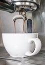 Espresso coffee for flat white being made in stainless steel mac Royalty Free Stock Photo