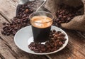 Espresso coffee in glass cup with coffee beans. Royalty Free Stock Photo