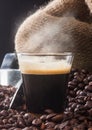 Espresso coffee in glass cup with coffee beans. Royalty Free Stock Photo