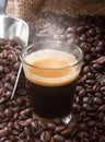 Espresso coffee in glass cup with coffee beans. Royalty Free Stock Photo