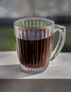 Espresso coffee in glass cup on wooden table with nature view background Royalty Free Stock Photo