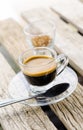 Espresso coffee in glass cup on wooden table Royalty Free Stock Photo