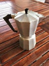 Classic Moka Pot on a Rustic Wooden Table, Coffee Brewing Charm