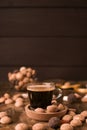 Espresso coffee poured into a glass of milk and Traditional sweets, cookies pepernoten on a wooden table. Copy space Royalty Free Stock Photo