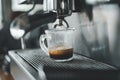 Espresso coffee pouring from espresso machine. Barista details in cafe