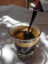 Espresso coffee with rum, sugar and lemon rind in a shot glass. Typical recipe of Livorno, Italy