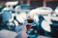 Espresso coffee on the street in Marrakech - Morocco. Man holding a cup of fresh brewed coffe on a iron plate with sugar. Royalty Free Stock Photo