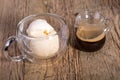 Espresso coffee and Vanilla ice cream in double walled glass italian dessert, on the rustic wooden table Royalty Free Stock Photo
