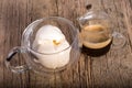 Espresso coffee and Vanilla ice cream in double walled glass italian dessert, on the rustic wooden table Royalty Free Stock Photo