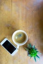 Espresso coffee in white cup with smartphone with copy space Royalty Free Stock Photo