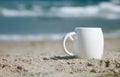 Espresso coffee in white cup with ocean waves Royalty Free Stock Photo