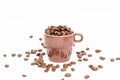 Espresso cup in brown filled with dark coffee beans on white background Royalty Free Stock Photo
