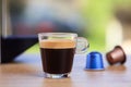 Espresso cup and coffee capsules on blur background, Closeup view with details Royalty Free Stock Photo