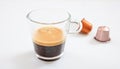 Espresso cup and coffee pods on white background, Closeup view with details Royalty Free Stock Photo