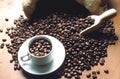 Espresso cup with beans inside the cup and near coffee beans Royalty Free Stock Photo