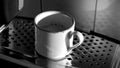 Espresso in a cup is on the stand of coffee machine Royalty Free Stock Photo