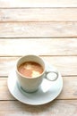 Espresso in the cup on the wooden background