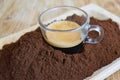 Espresso immersed in ground coffee Royalty Free Stock Photo