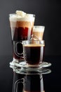 Espresso, latte macchiato and Irish coffee on black background