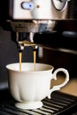 espresso machine making coffee and pouring in a white cup Royalty Free Stock Photo