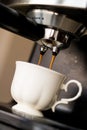 Espresso machine making coffee and pouring in a white cup Royalty Free Stock Photo