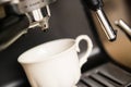 Espresso machine making coffee and pouring in a white cup Royalty Free Stock Photo