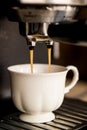 Espresso machine making coffee and pouring in a white cup Royalty Free Stock Photo