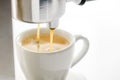 Espresso machine pouring strong fresh coffee into a ceramic cup Royalty Free Stock Photo