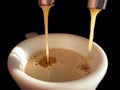 Espresso machine pouring strong fresh coffee into white ceramic cup closeup Royalty Free Stock Photo