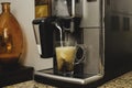 Espresso machine pours fresh cappuccino coffee close-up Royalty Free Stock Photo