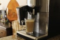 Espresso machine pours fresh cappuccino coffee close-up Royalty Free Stock Photo