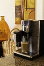 Espresso machine pours fresh cappuccino coffee close-up Royalty Free Stock Photo